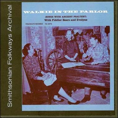 A cd cover of a group of people sitting at a piano

Description automatically generated