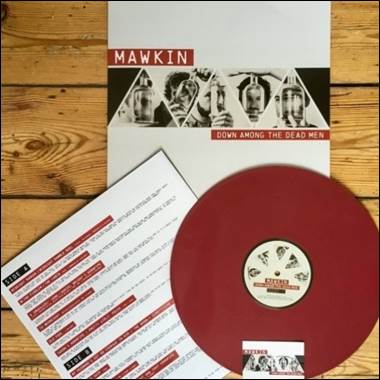 A red vinyl disc and a white paper on a wooden surface

Description automatically generated
