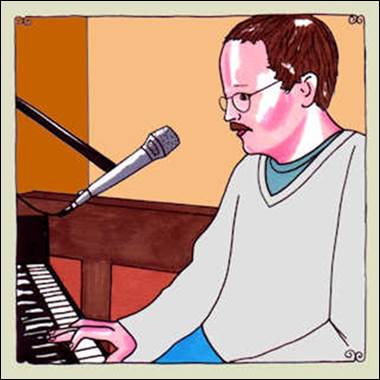 A person playing piano with a microphone

Description automatically generated