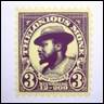 A purple and yellow stamp with a person in a hat

Description automatically generated