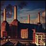 A large factory with smoke stacks with Battersea Power Station in the background

Description automatically generated