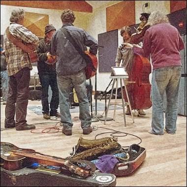 A group of people playing instruments

Description automatically generated