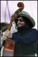 A person with a beard and a hat holding a guitar

Description automatically generated with low confidence