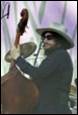 A person wearing a cowboy hat and sunglasses playing a guitar

Description automatically generated with low confidence