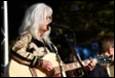 A person with white hair playing guitar

Description automatically generated with low confidence