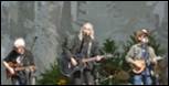A person with long hair playing guitar

Description automatically generated