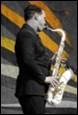A person playing a saxophone

Description automatically generated with medium confidence