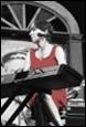 A person in a red dress playing a keyboard

Description automatically generated with low confidence
