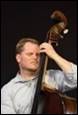 A person playing a double bass

Description automatically generated with medium confidence