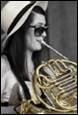 A person playing a french horn

Description automatically generated with medium confidence