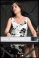 A person in a dress playing a keyboard

Description automatically generated with low confidence
