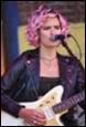 A person with pink hair playing a guitar

Description automatically generated with medium confidence