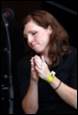 A person praying with her hands together

Description automatically generated