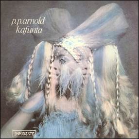 A person with long hair and a feathered headdress
Description automatically generated