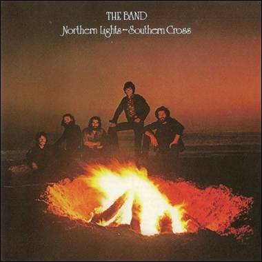 A group of men standing around a fire

Description automatically generated