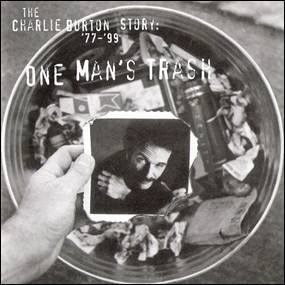 A hand holding a picture of a person in a trash can
Description automatically generated