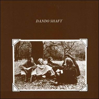 A group of people sitting in the grass

Description automatically generated