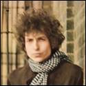 A person with curly hair wearing a scarf

Description automatically generated