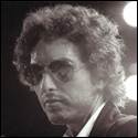 A person with curly hair wearing sunglasses

Description automatically generated
