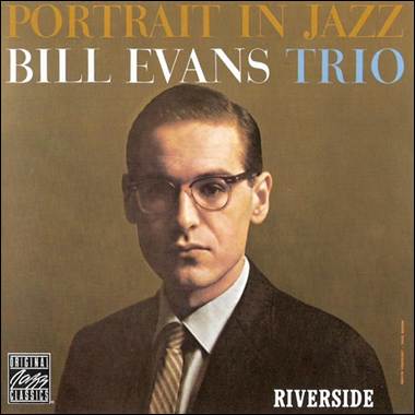 A person wearing glasses and a suit
Description automatically generated