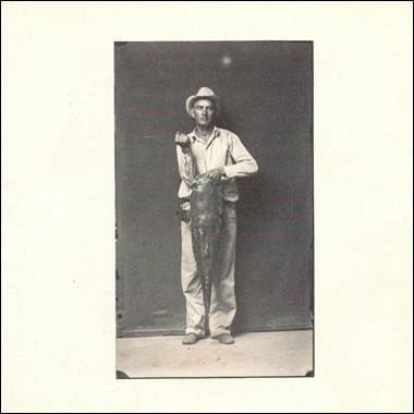 A person holding a fish

Description automatically generated