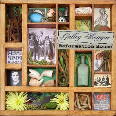 A wooden box with pictures and objects in it

Description automatically generated