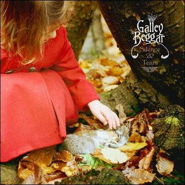 A child in a red coat playing with a squirrel

Description automatically generated