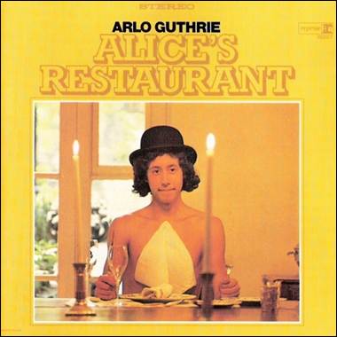 A person sitting at a table with a glass of wine

Description automatically generated