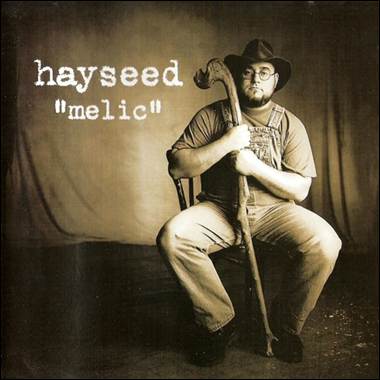 A person in a cowboy hat holding a cane

Description automatically generated