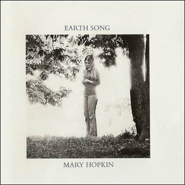 A person standing in grass under a tree
Description automatically generated