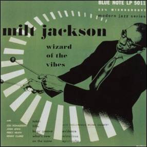 A person in a suit and tie playing instruments
Description automatically generated
