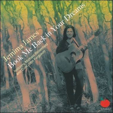 A person holding a guitar in a forest

Description automatically generated