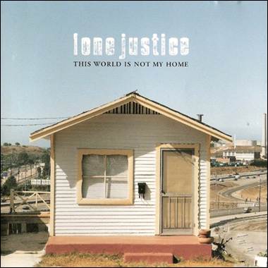 A small white house with a railing
Description automatically generated