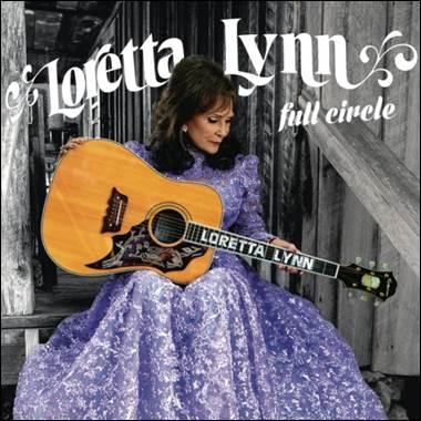 A person in a purple dress holding a guitar

Description automatically generated