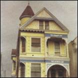 A yellow house with a pointed roof

Description automatically generated