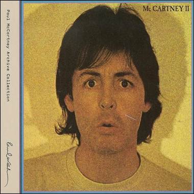 A person with long hair and a yellow background
Description automatically generated