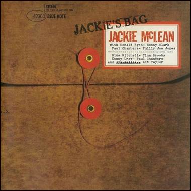 A brown envelope with red and white labels

Description automatically generated