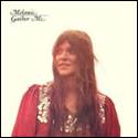 A person with long hair wearing a red dress

Description automatically generated
