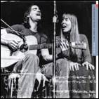 A person and person singing and playing guitar
Description automatically generated