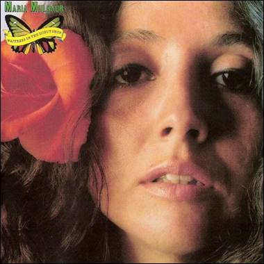 A person with a flower in her hair
Description automatically generated