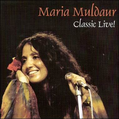 A person holding a flower in her hand
Description automatically generated