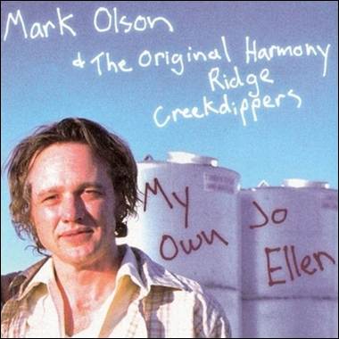 A person standing in front of white barrels

Description automatically generated