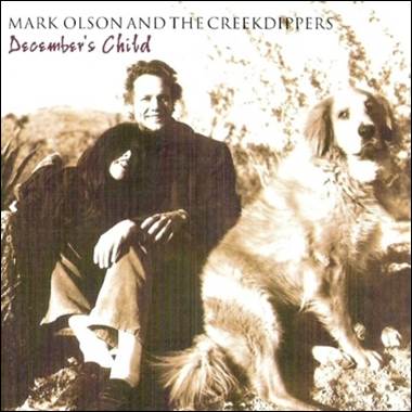 A person and a dog sitting on a rock

Description automatically generated