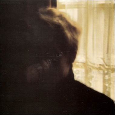 A person looking out a window
Description automatically generated