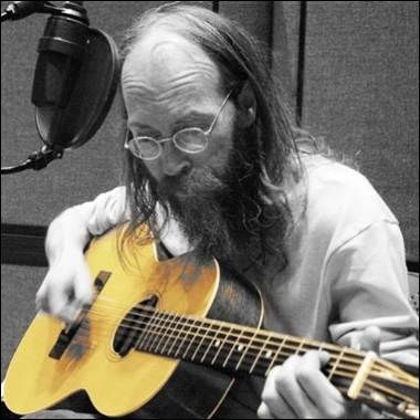 A person playing a guitar
Description automatically generated