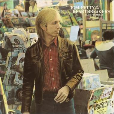 A person standing in front of a record store

Description automatically generated