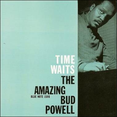 A person leaning against a desk
Description automatically generated