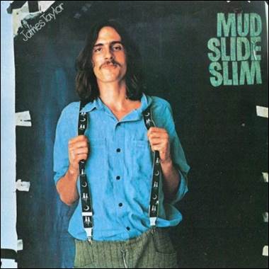 A person with long hair wearing suspenders

Description automatically generated