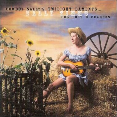 A person sitting on a hay bale holding a guitar

Description automatically generated