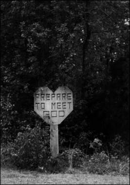 A heart shaped sign with text on it
Description automatically generated